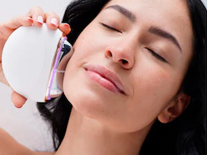 woman using AuraLift Gua Sha on jawline
