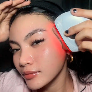 woman using AuraLift Gua Sha on lobes