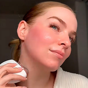 pretty woman using AuraLift Gua Sha on neck