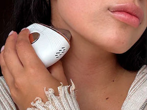 woman using AuraLift Gua Sha on neck for lymphatic drainage